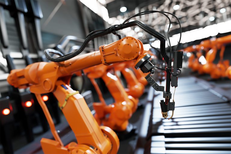 Robotic arms along assembly line in modern factory